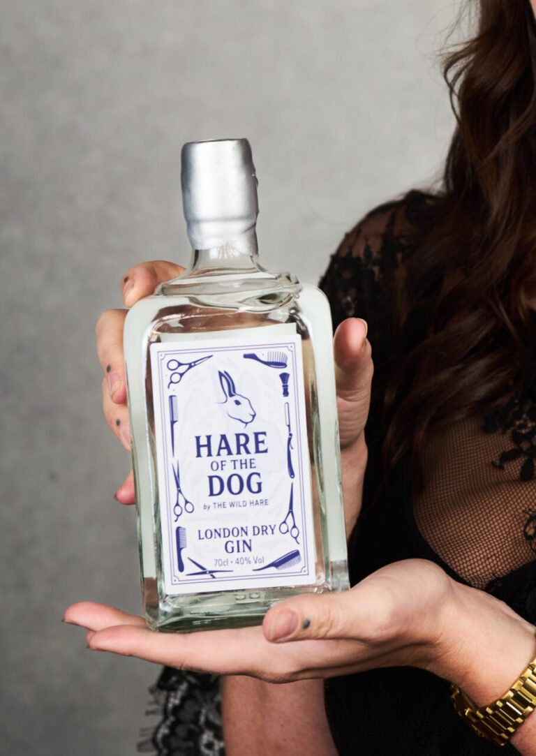 Hands holding a bottle of the Hare OF The Dog Gin by The Wild Hare